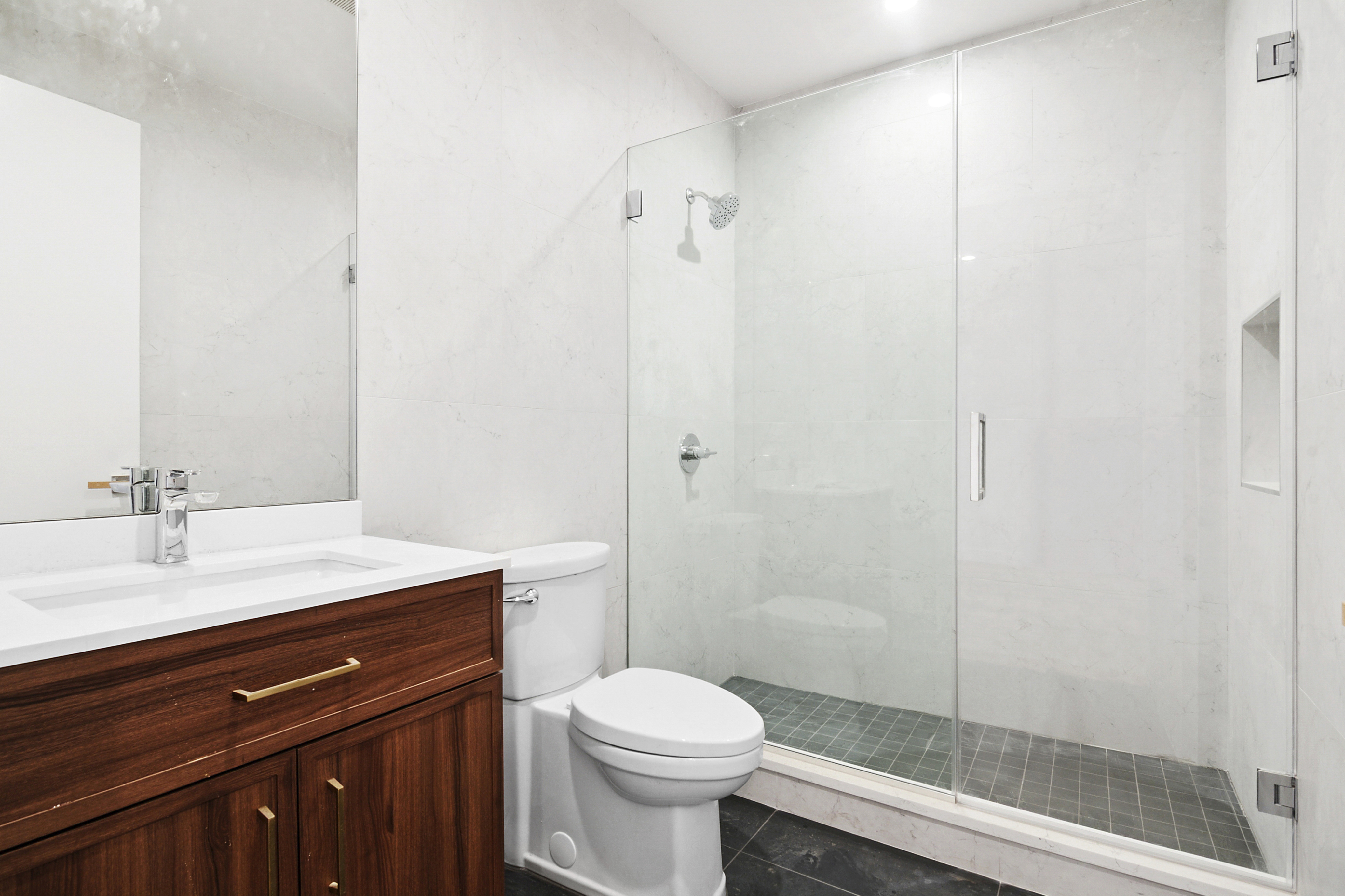 212 Montrose Avenue, Unit 3F Brooklyn, NY 11206 - Photo 4 of 9 a bathroom with a sink a toilet and shower