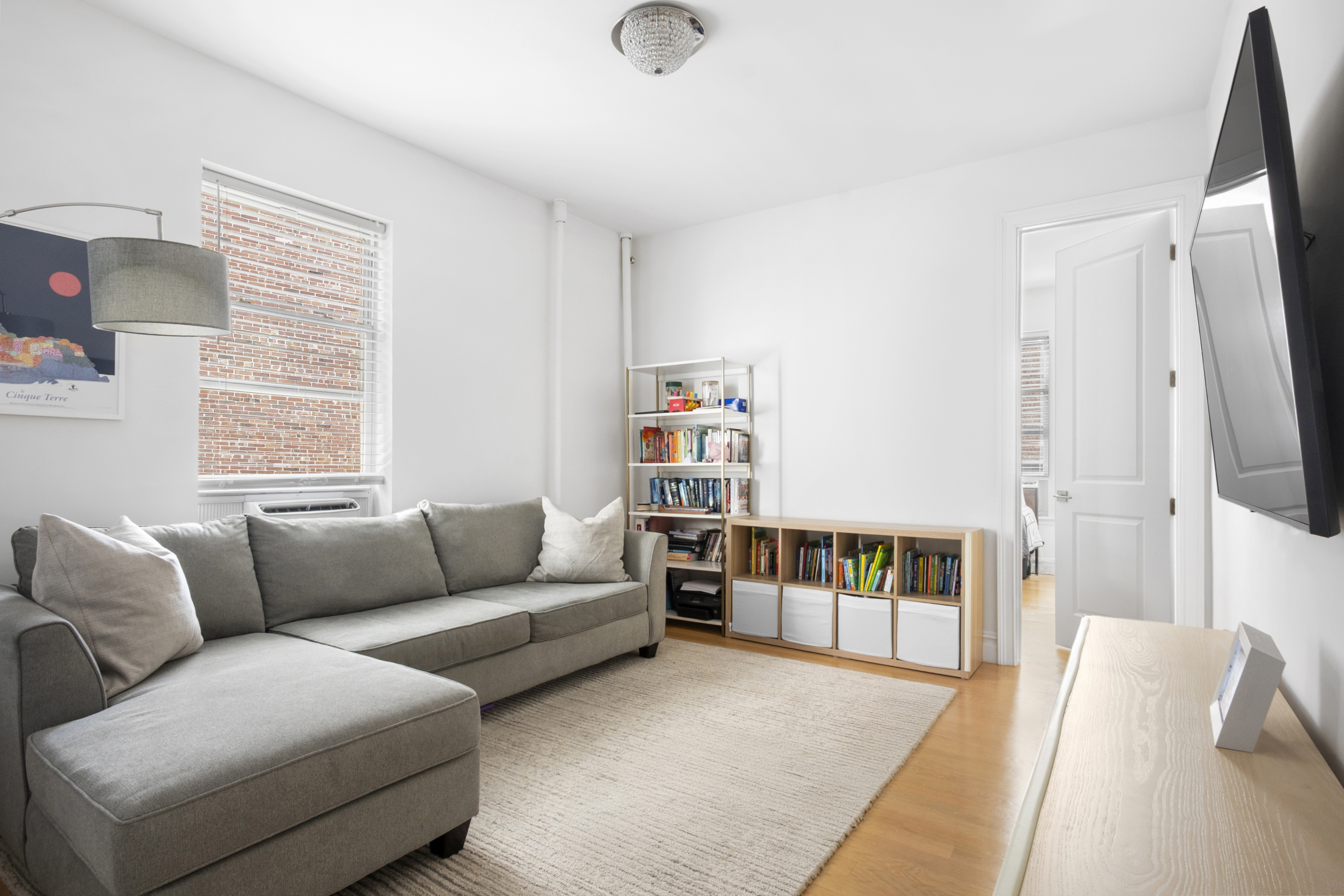 345 West 70th Street, Unit 5E Manhattan, NY 10023 - Photo 3 of 10 a living room with furniture and a flat screen tv