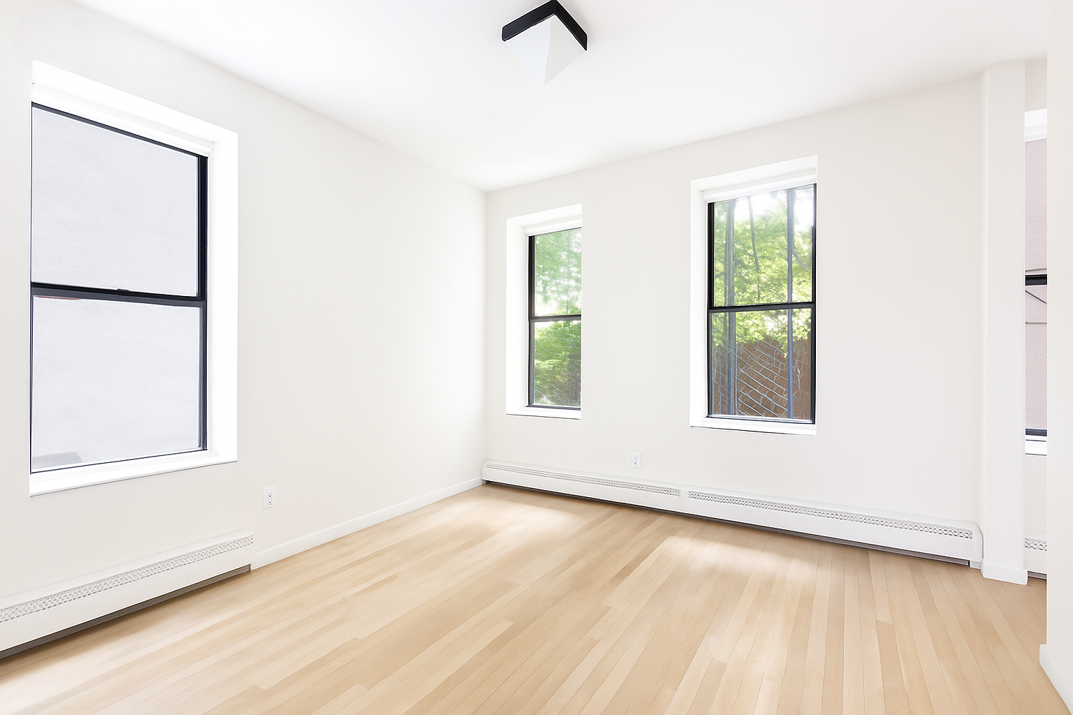 99 Avenue B, Unit 1B Manhattan, NY 10009 - Photo 2 of 8 an empty room with wooden floor and windows