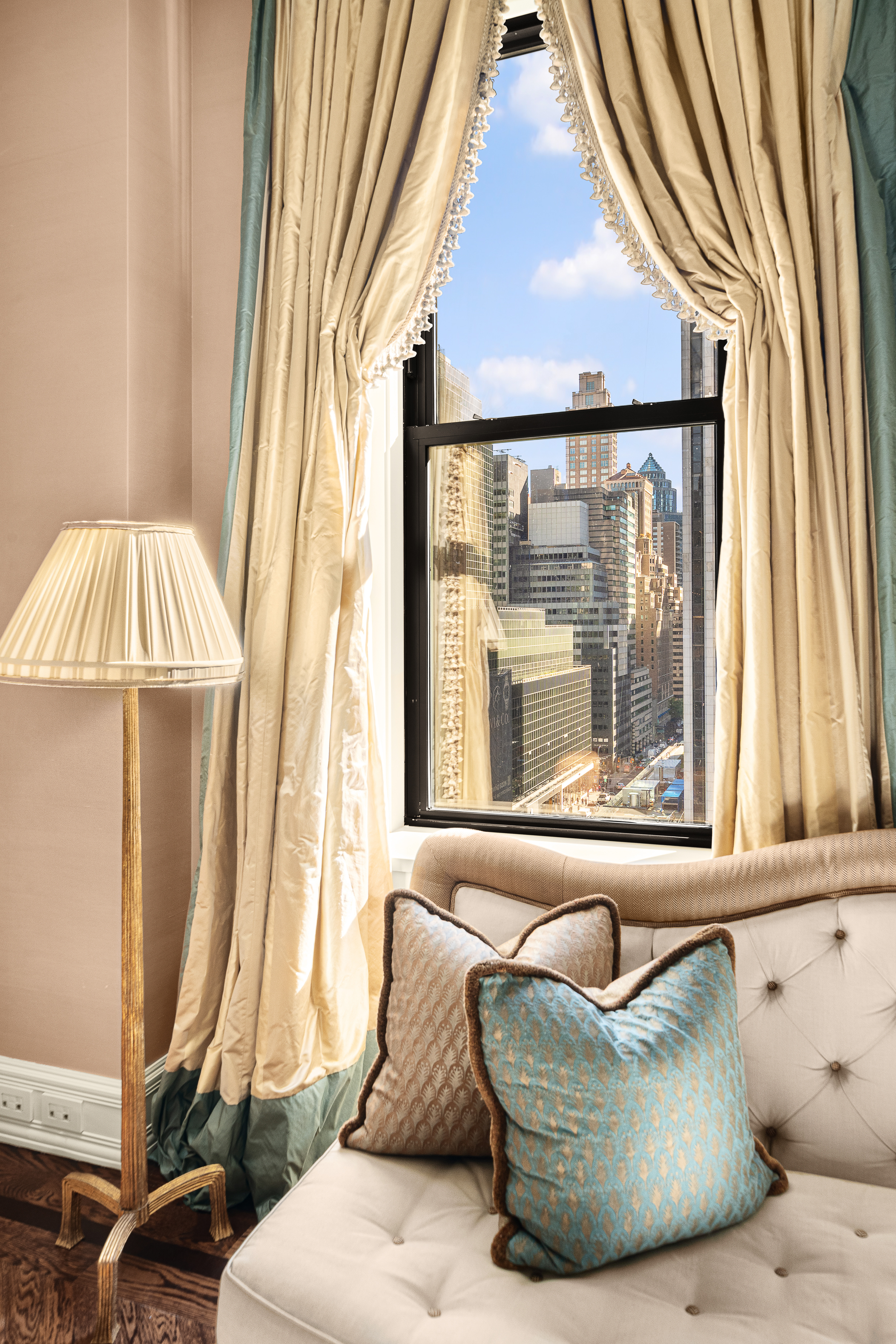 1 Central Park South, Unit 1013 Manhattan, NY 10019 - Photo 5 of 32 a living room with a couch and a table