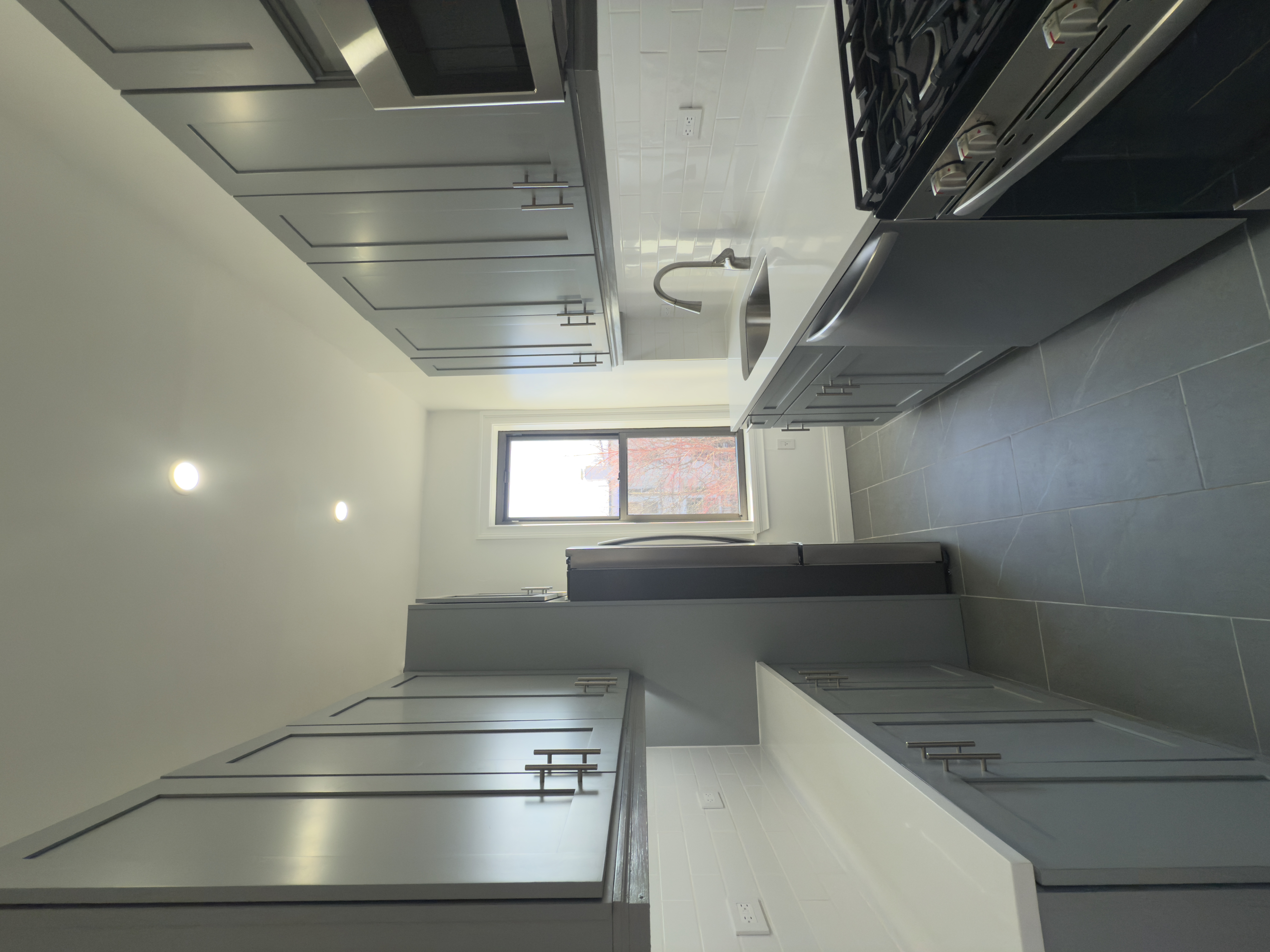 82 74th Street Brooklyn, NY 11209 - Photo 5 of 21 a kitchen with stainless steel appliances granite countertop a sink stove and refrigerator
