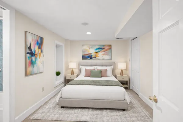 a bedroom with a bed and painting on the wall