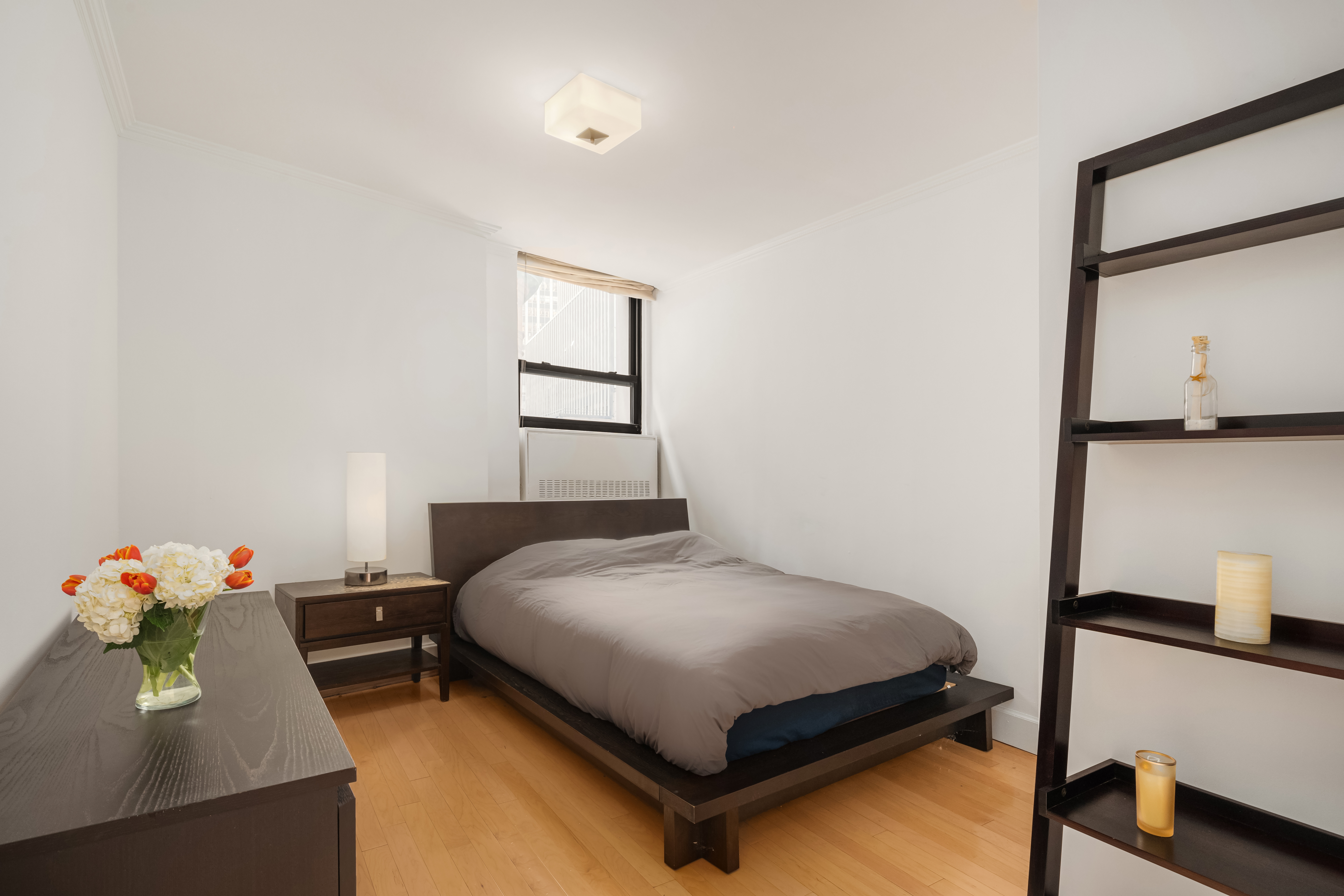 3 Hanover Square, Unit 4E Manhattan, NY 10004 - Photo 3 of 7 a bedroom with a bed and a dresser