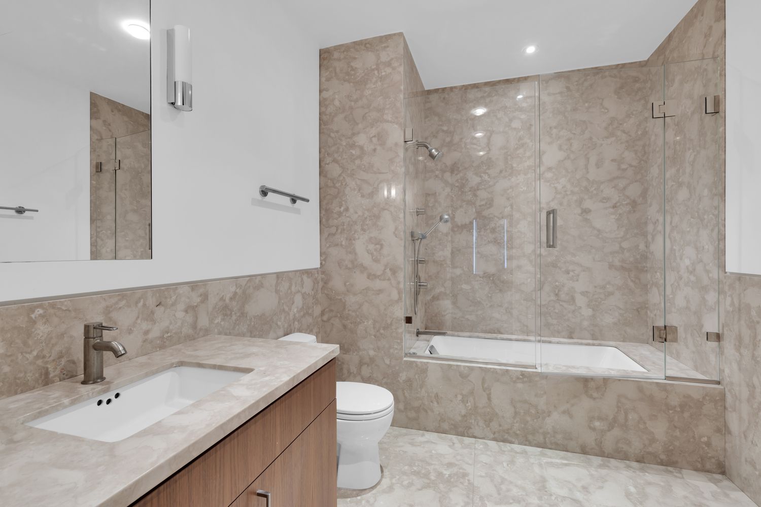 42 West 71st Street Manhattan, NY 10023 - Photo 27 of 35 a bathroom with a granite countertop sink a toilet and shower