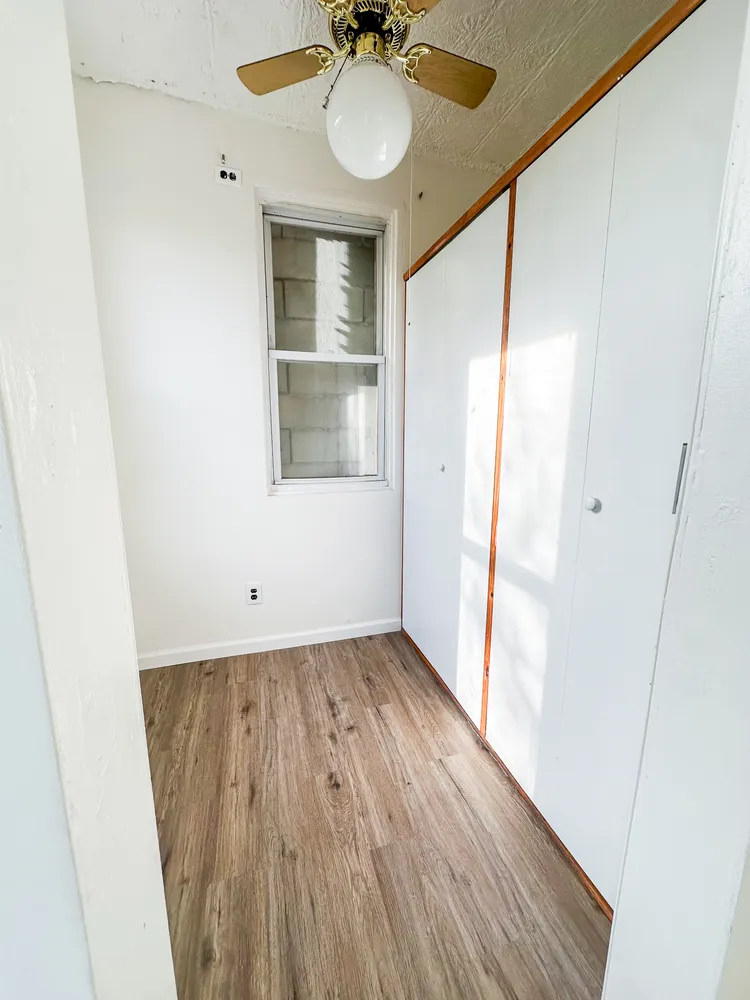 wooden floor in an empty room with a window