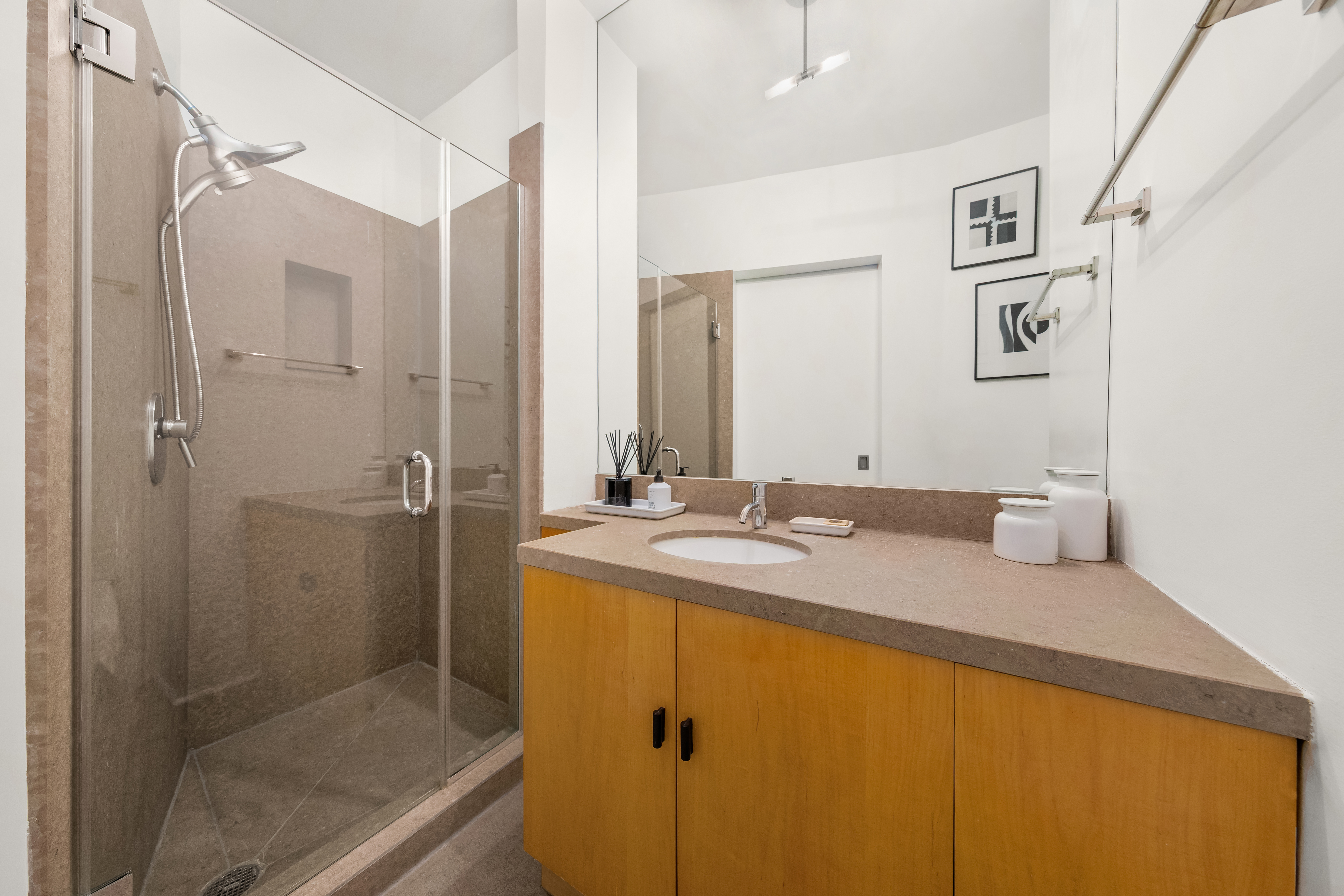 448 West 37th Street, Unit 11G/12G Manhattan, NY 10018 - Photo 14 of 17 a bathroom with a granite countertop sink mirror and double