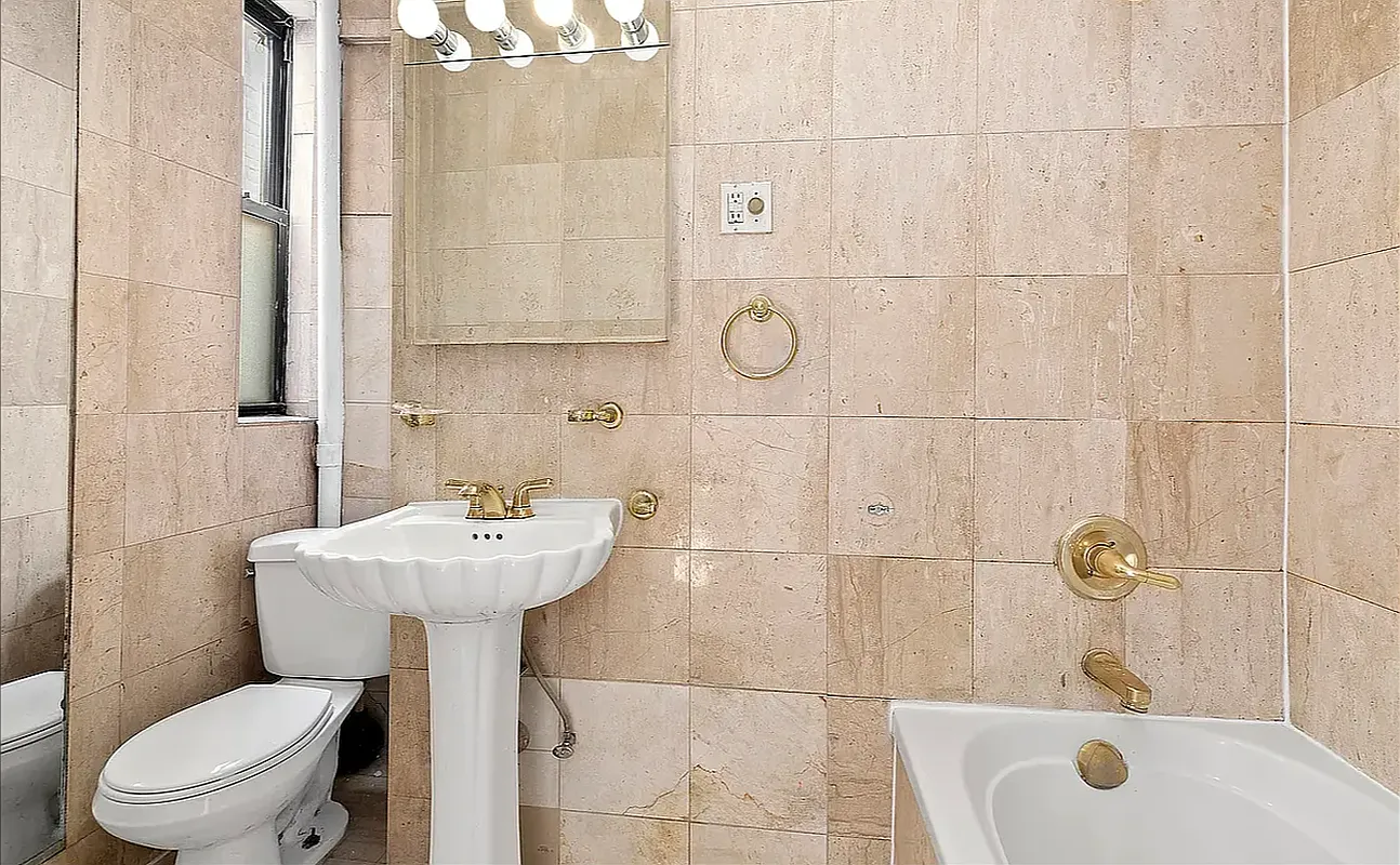 1313 3rd Avenue, Unit 3RN Manhattan, NY 10021 - Photo 4 of 7 a bathroom with a sink a toilet and shower