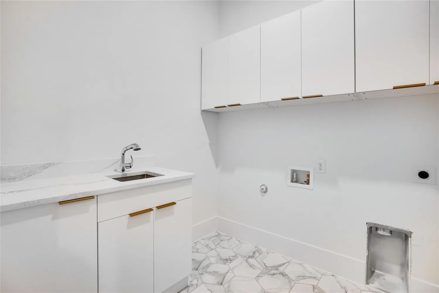 a view of a sink and cabinets in a room