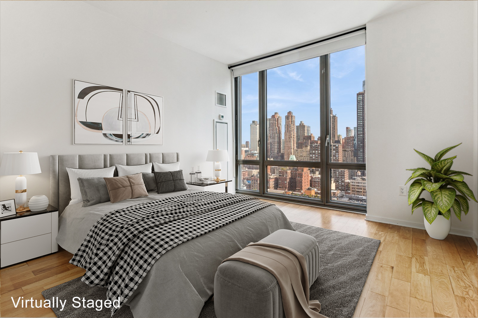 310 West 52nd Street, Unit 22H Manhattan, NY 10019 - Photo 6 of 12 a bedroom with a large bed and a potted plant