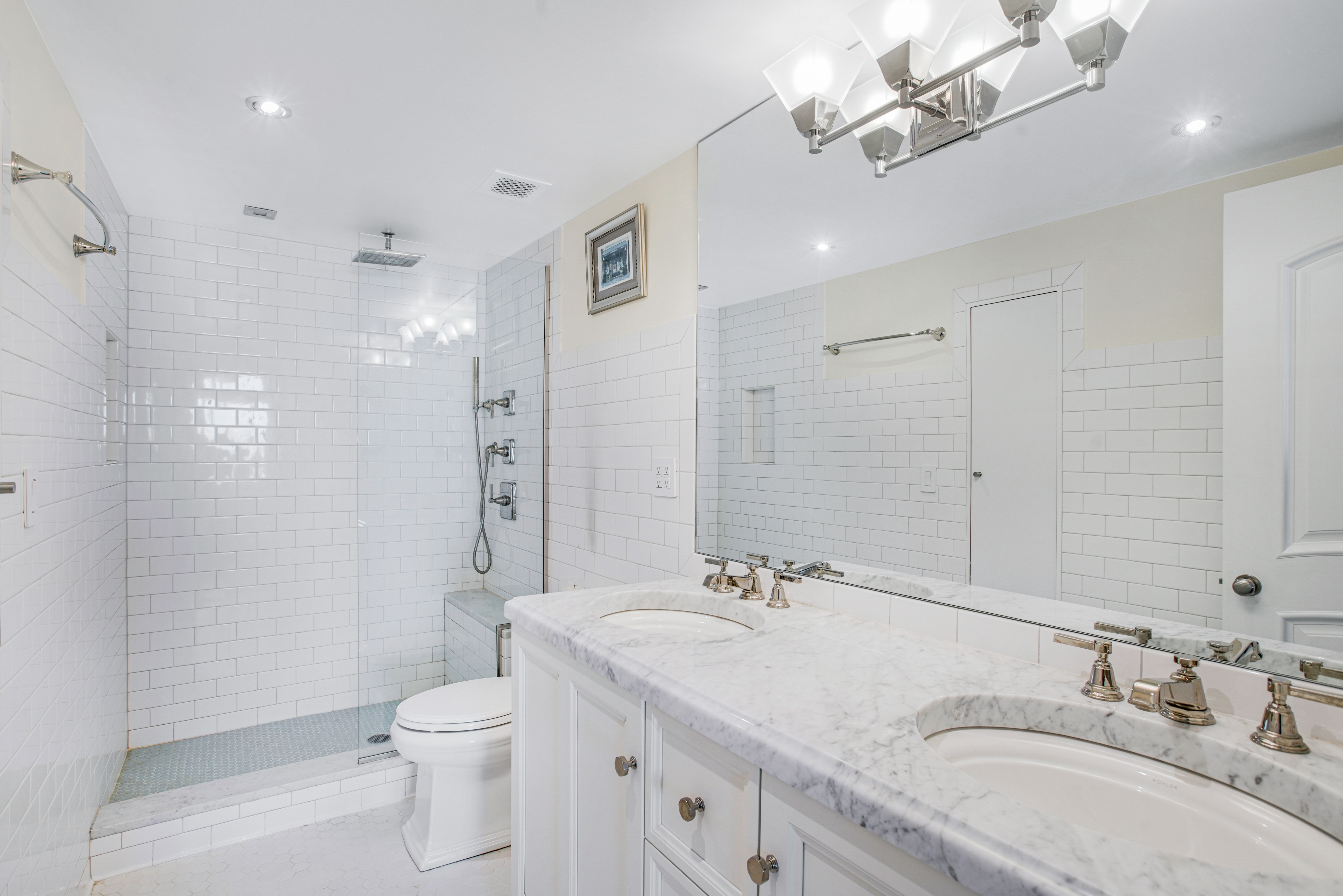 400 East 70th Street, Unit 3301 Manhattan, NY 10021 - Photo 10 of 20 a view of bathroom with a sink mirror and toilet