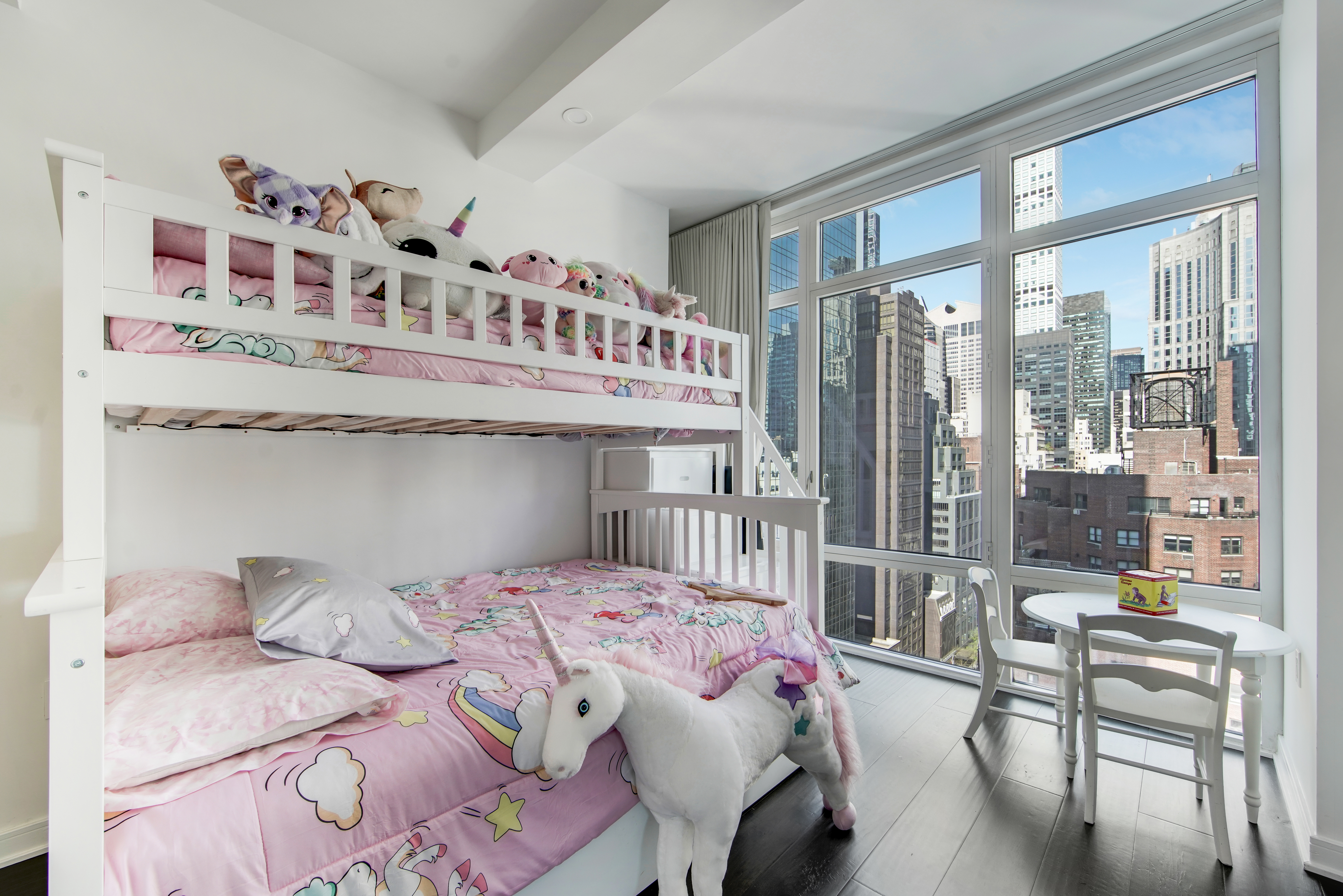 207 East 57th Street, Unit 20A Manhattan, NY 10022 - Photo 12 of 18 a bedroom with a bed a table and chair