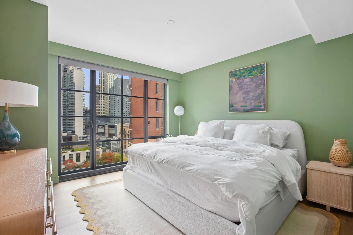 a spacious bedroom with a bed and a large window