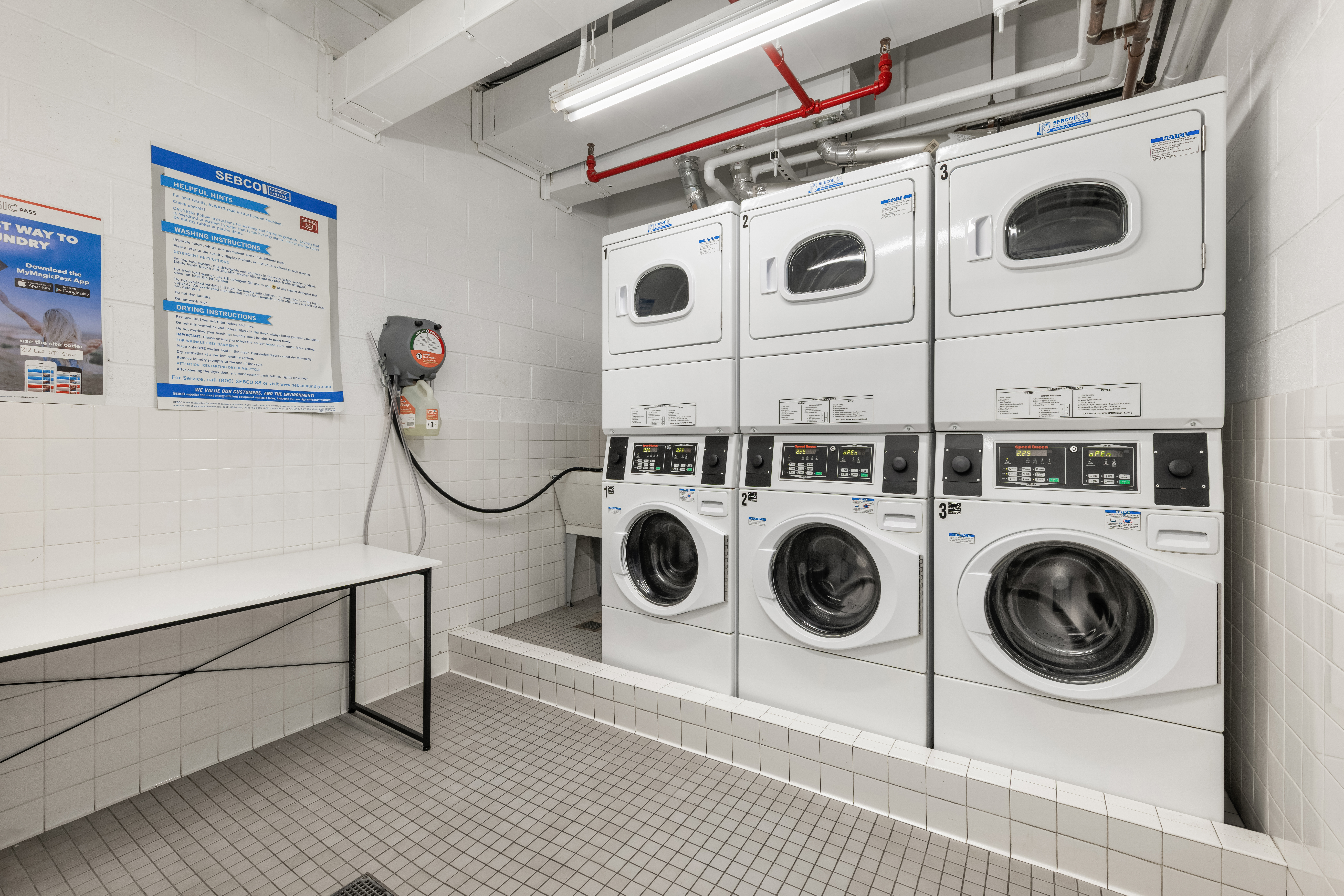 212 East 57th Street, Unit 3B Manhattan, NY 10022 - Photo 12 of 17 a utility room with dryer and washer
