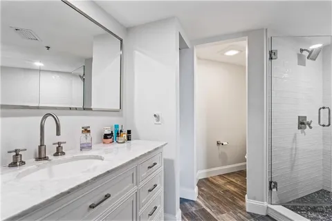 a bathroom with a granite countertop sink mirror vanity and toilet