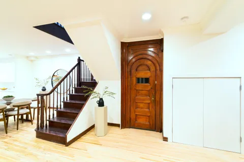 a view of entryway and hall with wooden floor