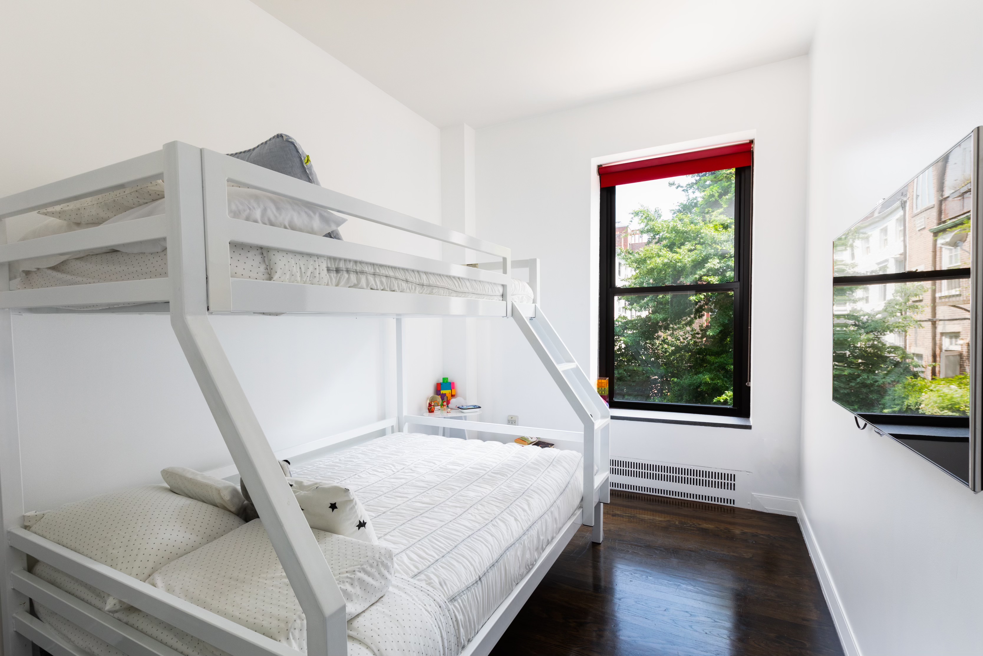 422 West 20th Street, Unit 3G Manhattan, NY 10011 - Photo 8 of 15 a view of room with window and wooden floor