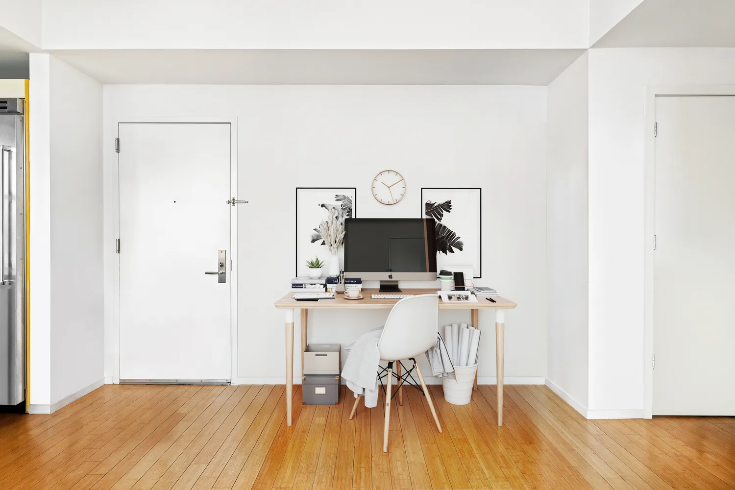 a view of a workspace with furniture and wooden floor