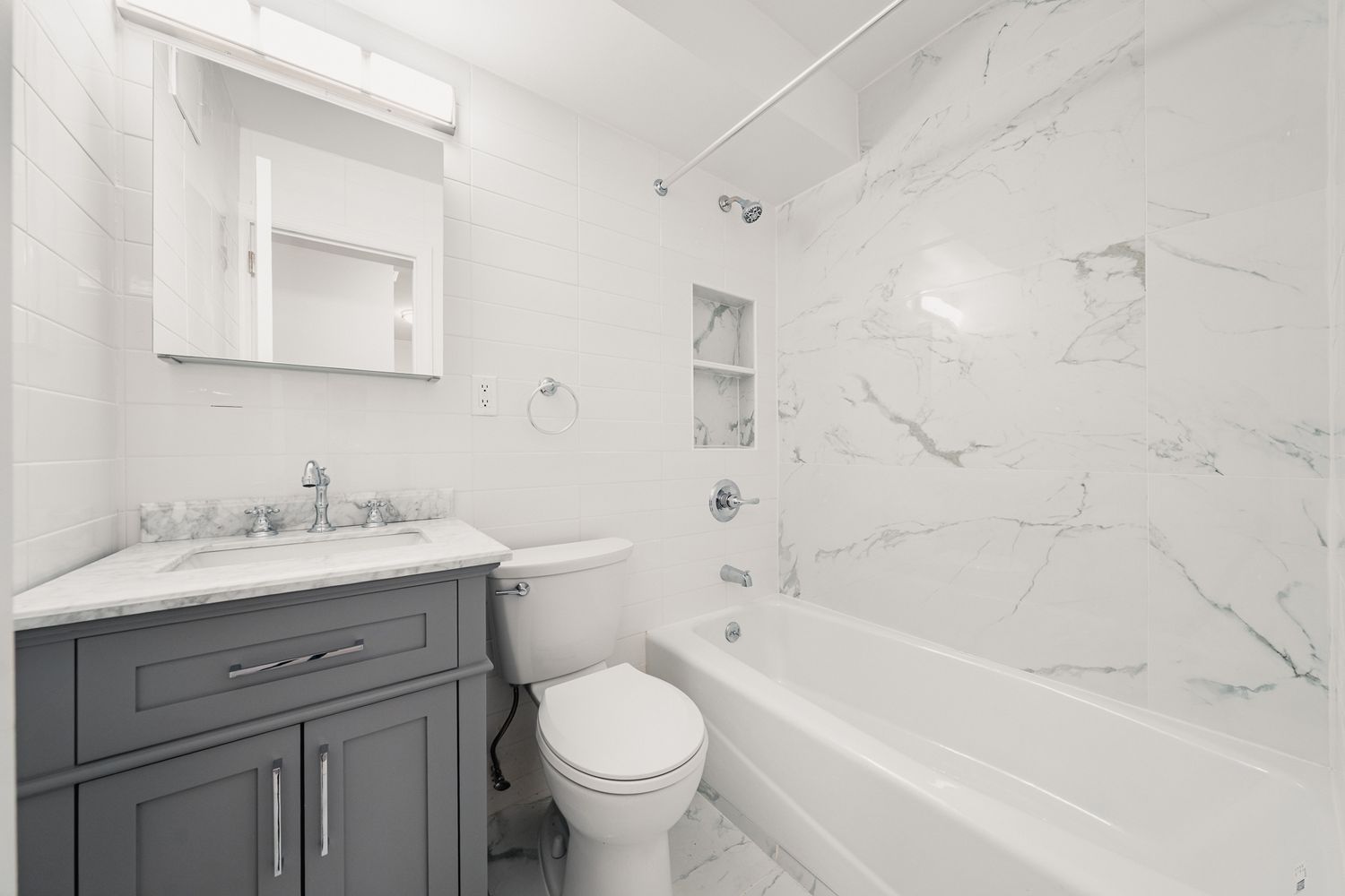 a bathroom with a granite countertop sink toilet and bathtub