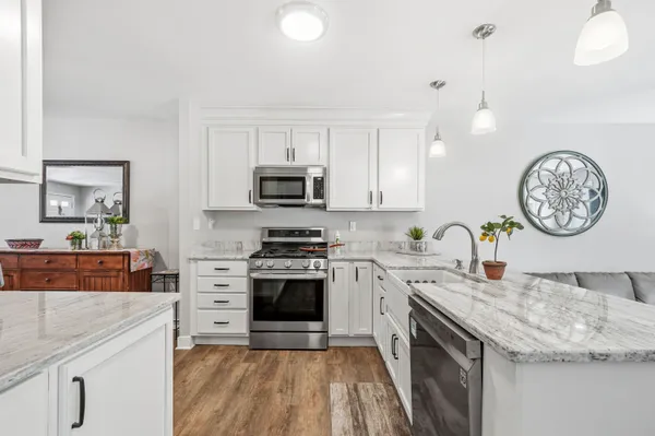 a kitchen with a stove a sink and a refrigerator