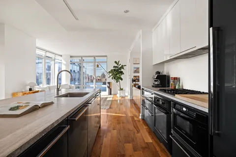 a large kitchen with granite countertop a lot of counter space and stainless steel appliances