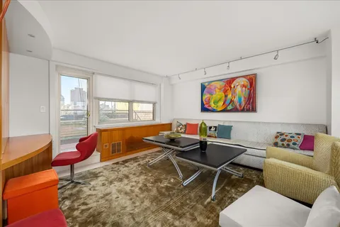 a living room with furniture a rug and a large window