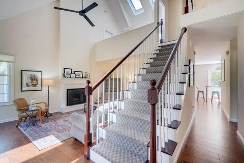 a living room with furniture a rug and a fireplace