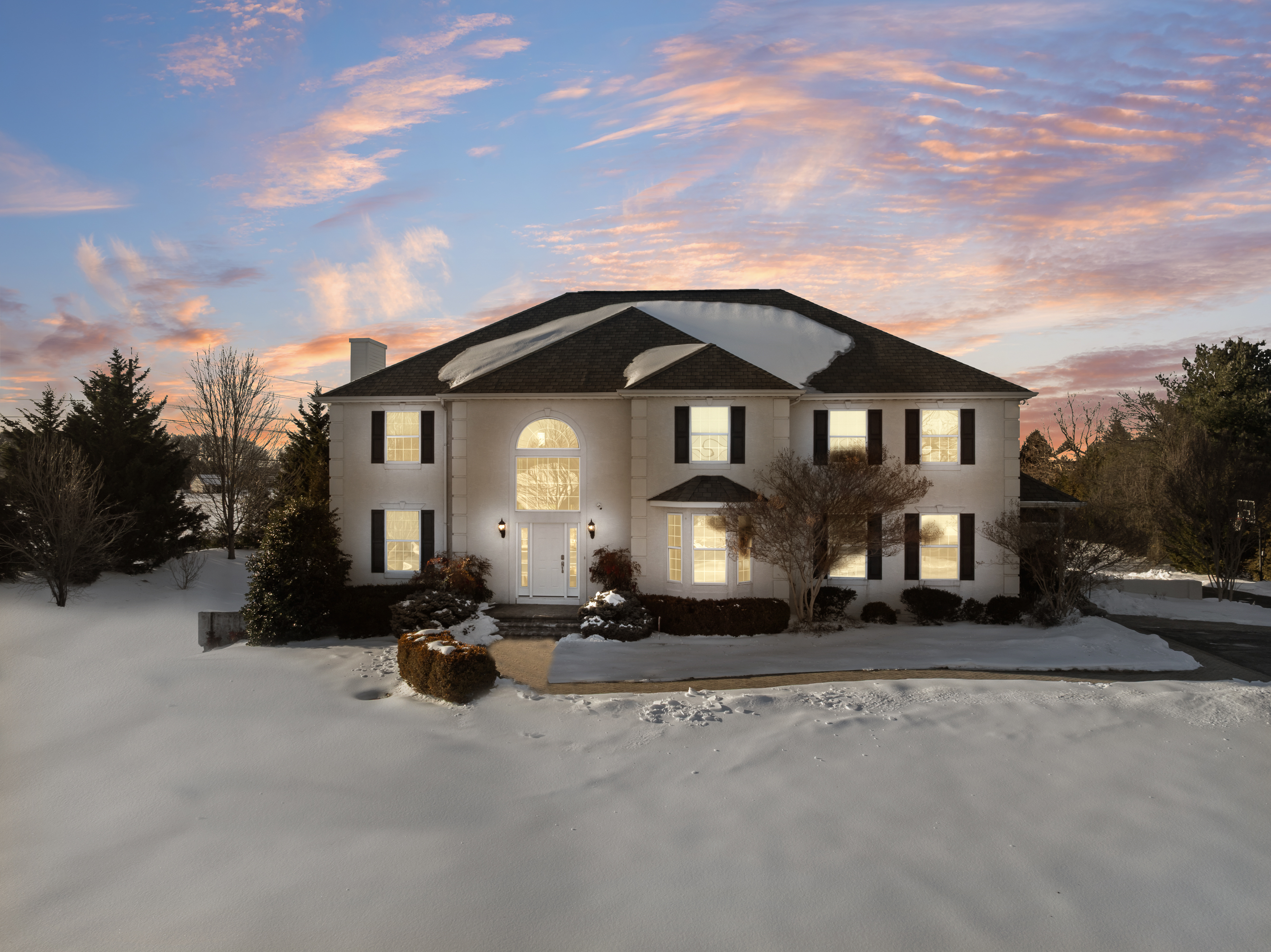a front view of a house with a garden