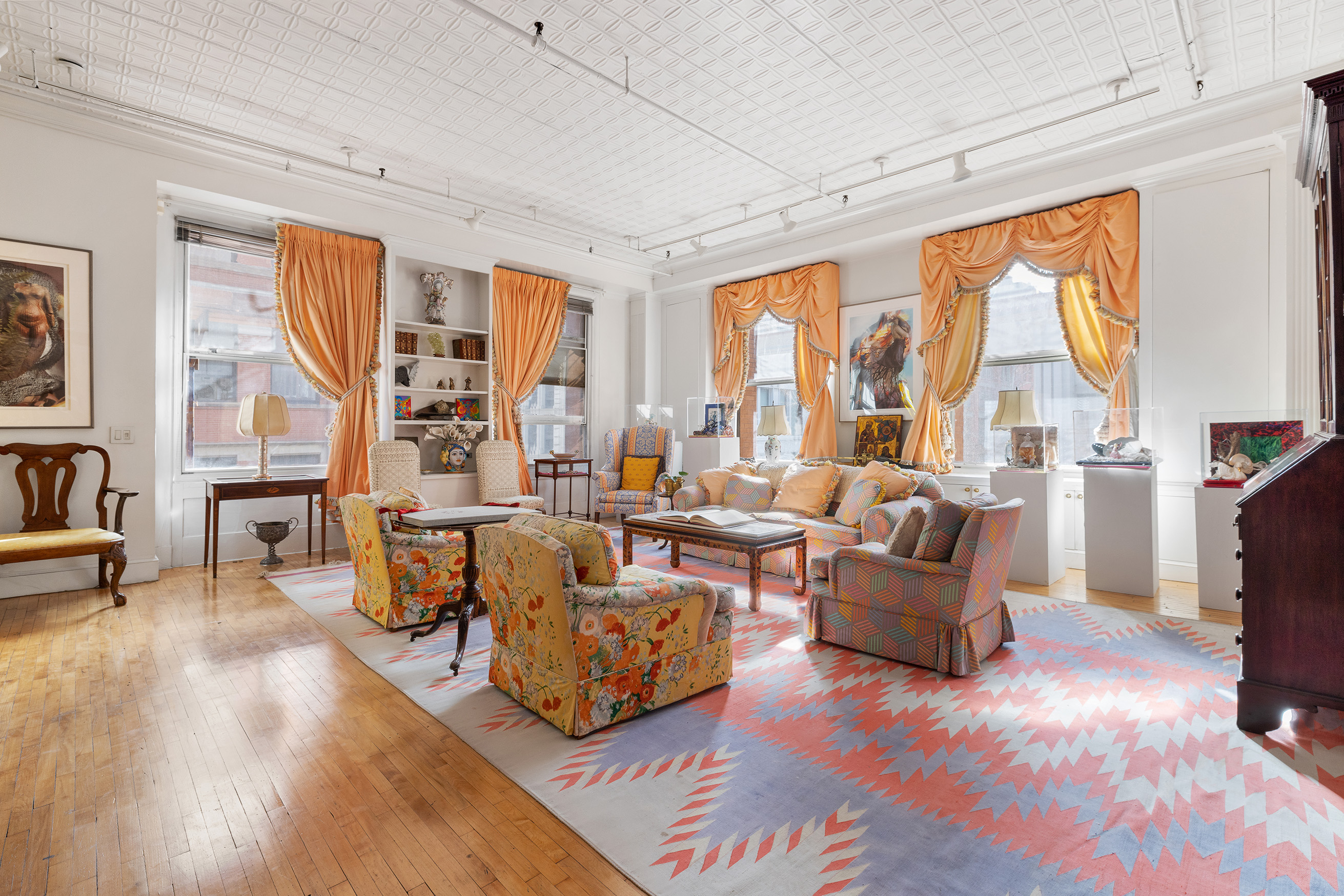 59 Wooster Street, Unit 3E Manhattan, NY 10012 - Photo 2 of 12 a living room with fireplace furniture and a large window