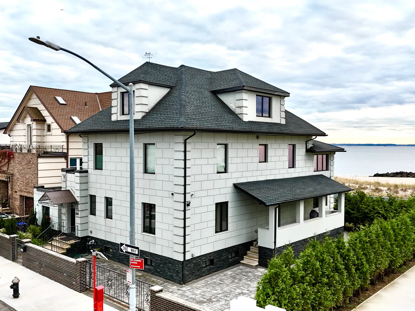 a front view of a house with plants