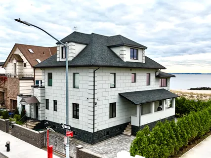a front view of a house with plants