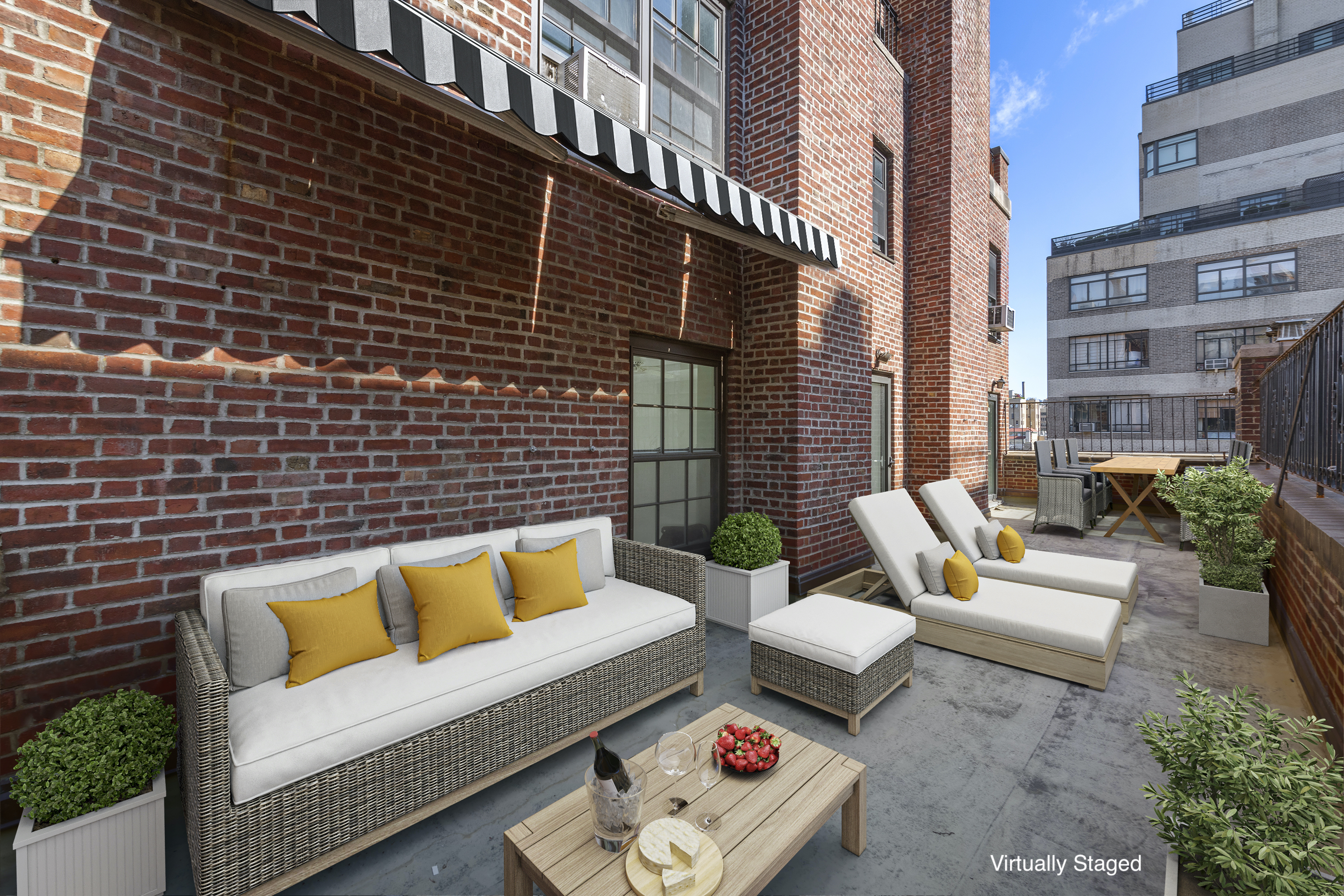 12 East 88th Street, Unit PH11/12B Manhattan, NY 10128 - Photo 18 of 22 a view of a patio with couches and a potted plant on a table