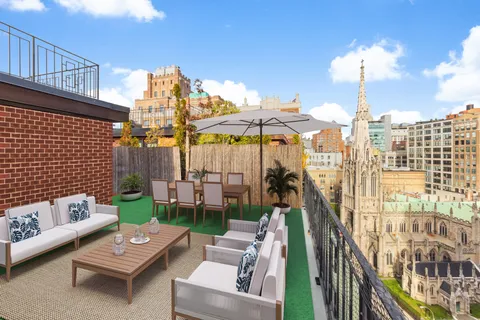 a view of a terrace with couches and pool view