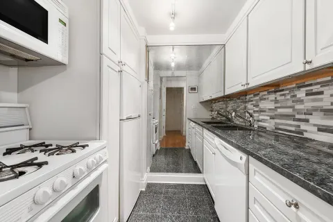 a kitchen with stainless steel appliances granite countertop a stove and a refrigerator
