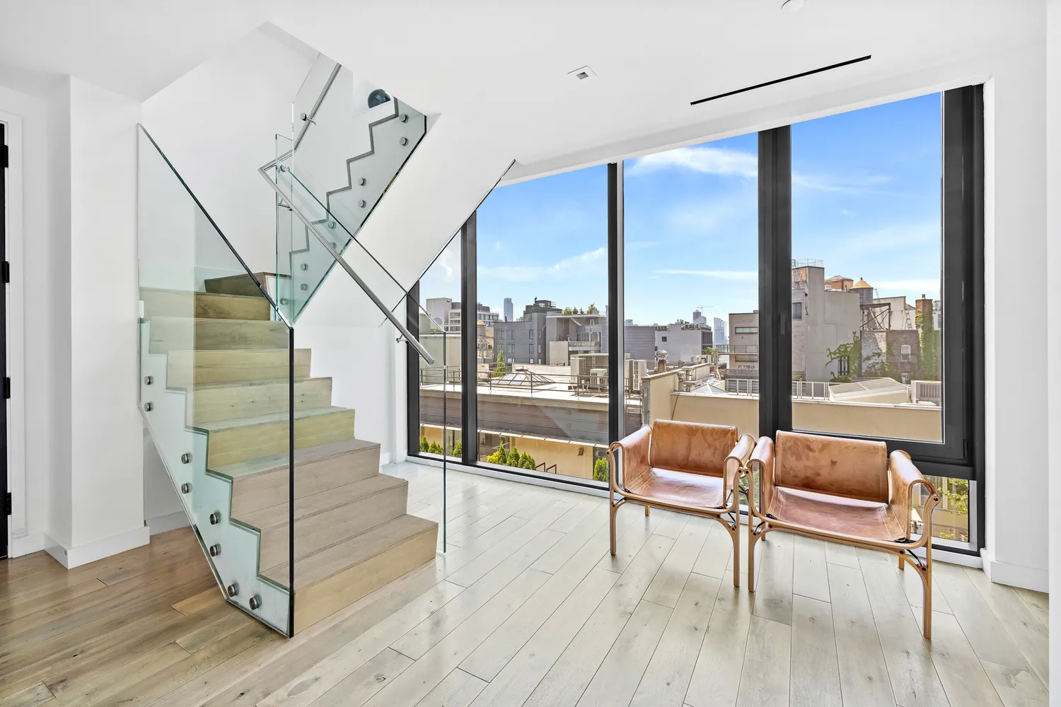 a living room with furniture and a floor to ceiling window