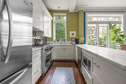 a kitchen with a sink stove and refrigerator