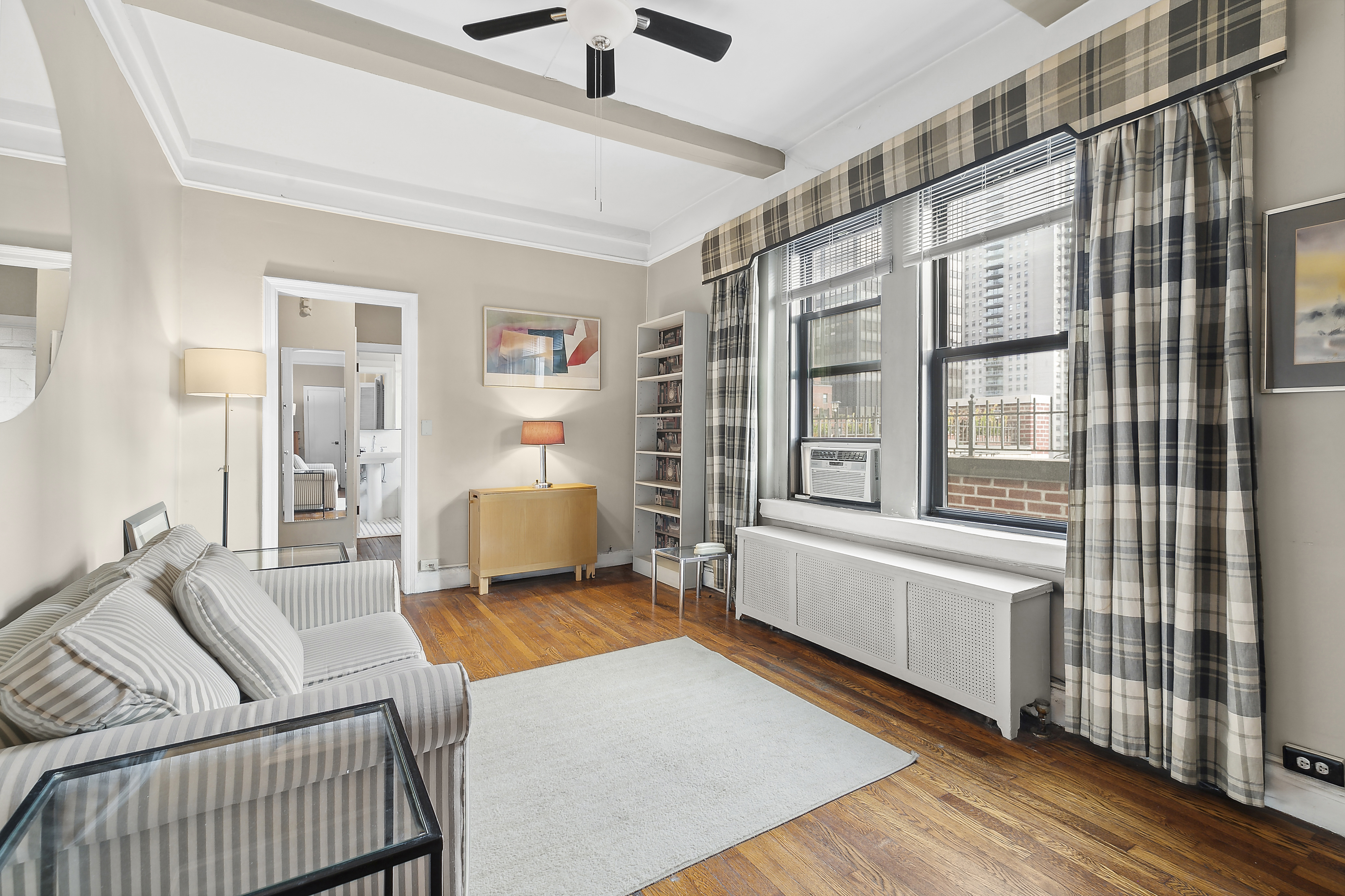321 East 54th Street Manhattan, NY 10022 - Photo 2 of 5 a living room with furniture and a window