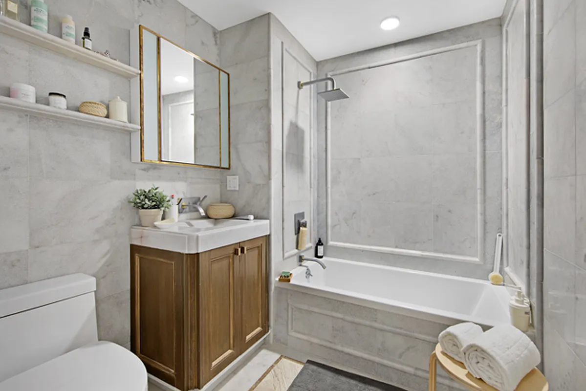 863 Saint Marks Avenue, Unit 4A Brooklyn, NY 11213 - Photo 4 of 6 a bathroom with a granite countertop sink toilet and shower
