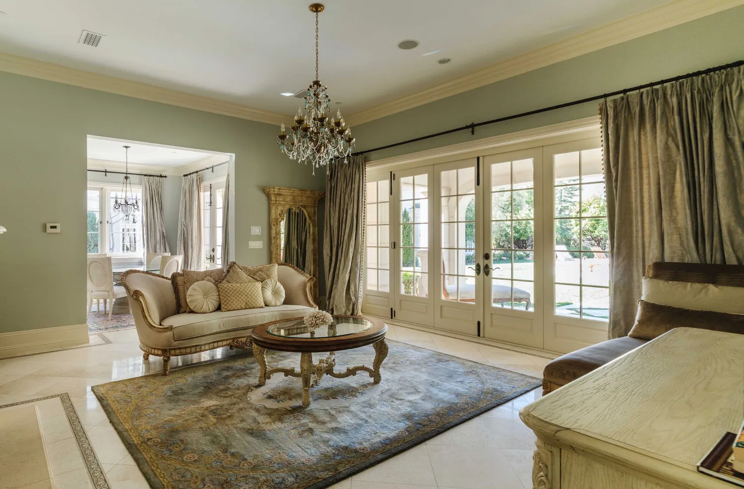 a living room with furniture and a chandelier