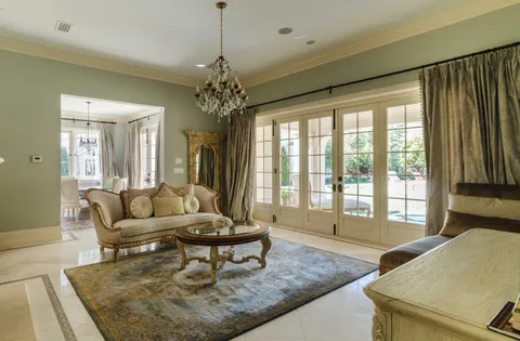 a living room with furniture and a chandelier
