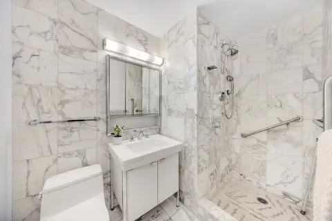 a bathroom with a sink toilet and shower