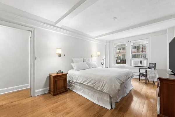 a spacious bedroom with a bed and a table in it