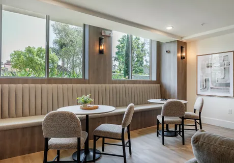 a dining room with furniture and window