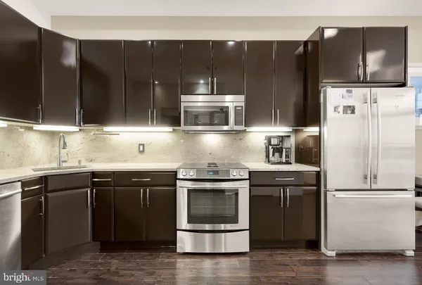 a kitchen with a refrigerator stove and cabinets