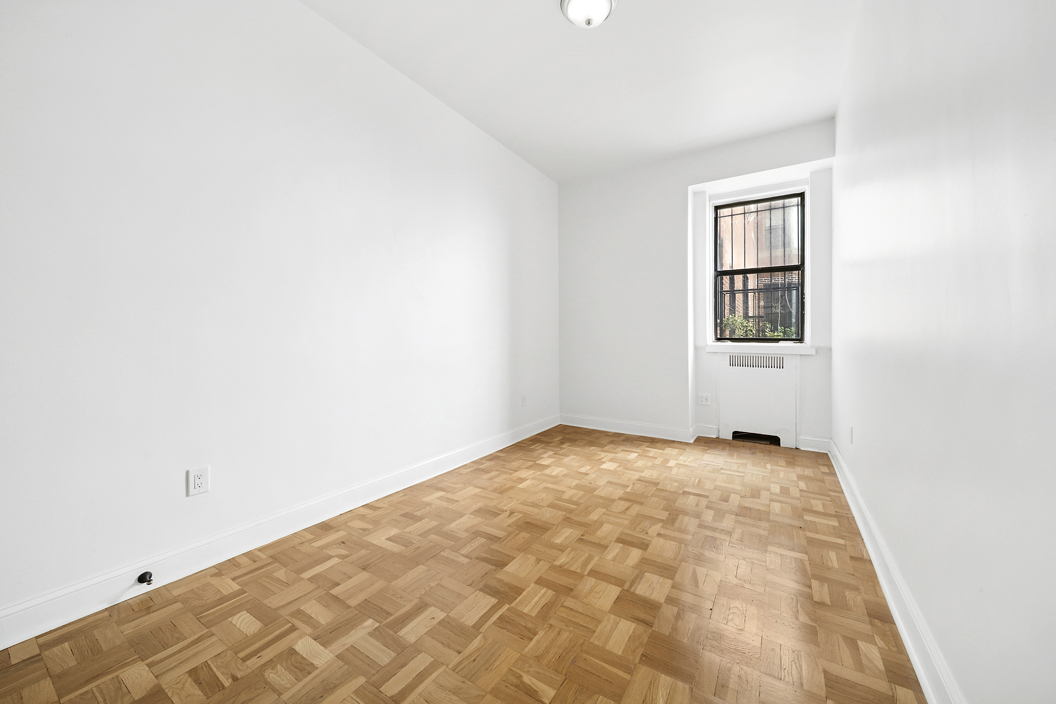 159-00 Riverside Drive West, Unit 1L70 Manhattan, NY 10032 - Photo 6 of 17 a view of an empty room and window
