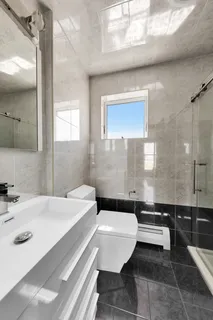 a bathroom with a sink a toilet and a mirror