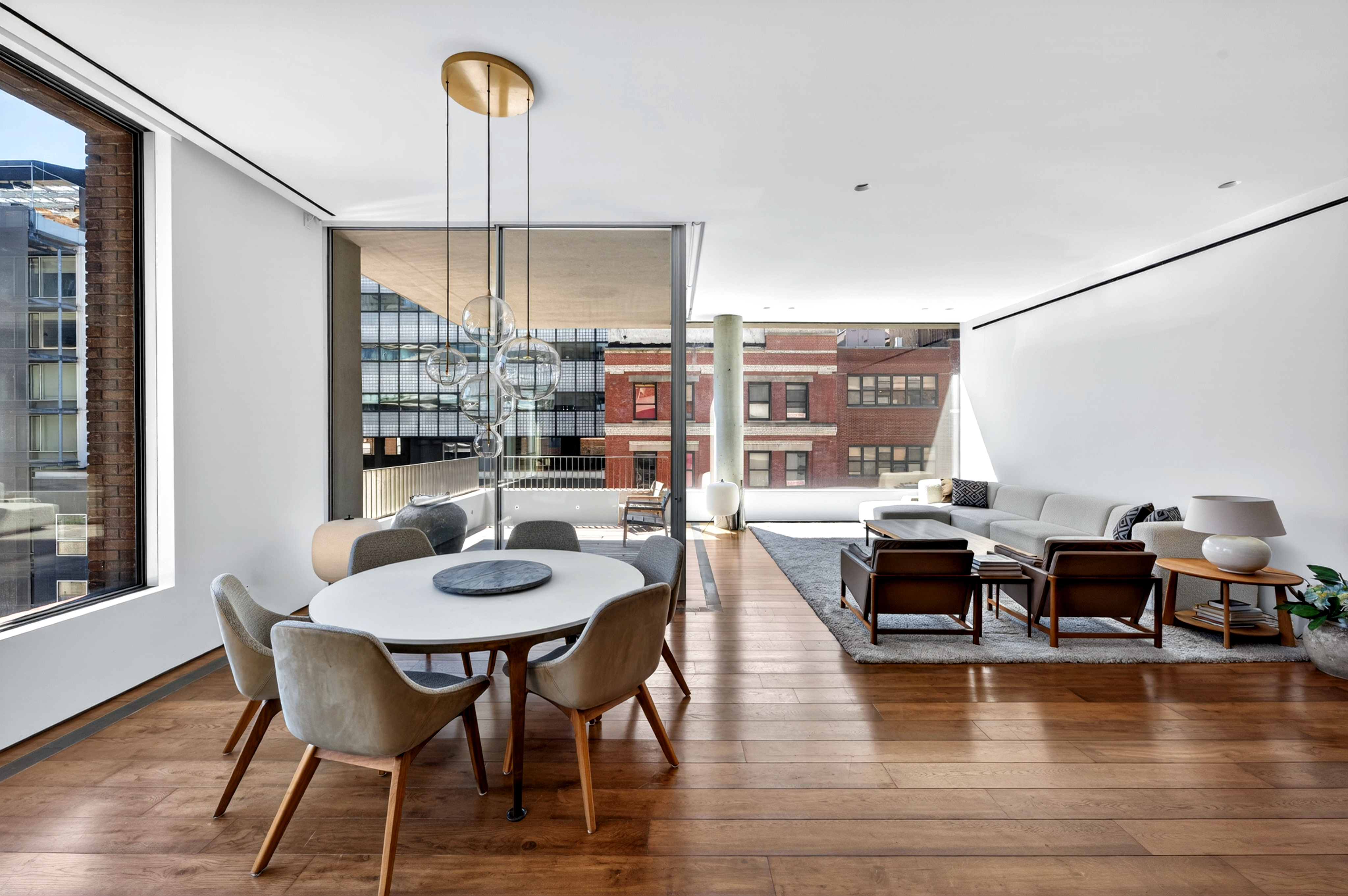 527 West 27th Street, Unit 6S Manhattan, NY 10001 - Photo 5 of 19 a dining room with furniture a chandelier and wooden floor