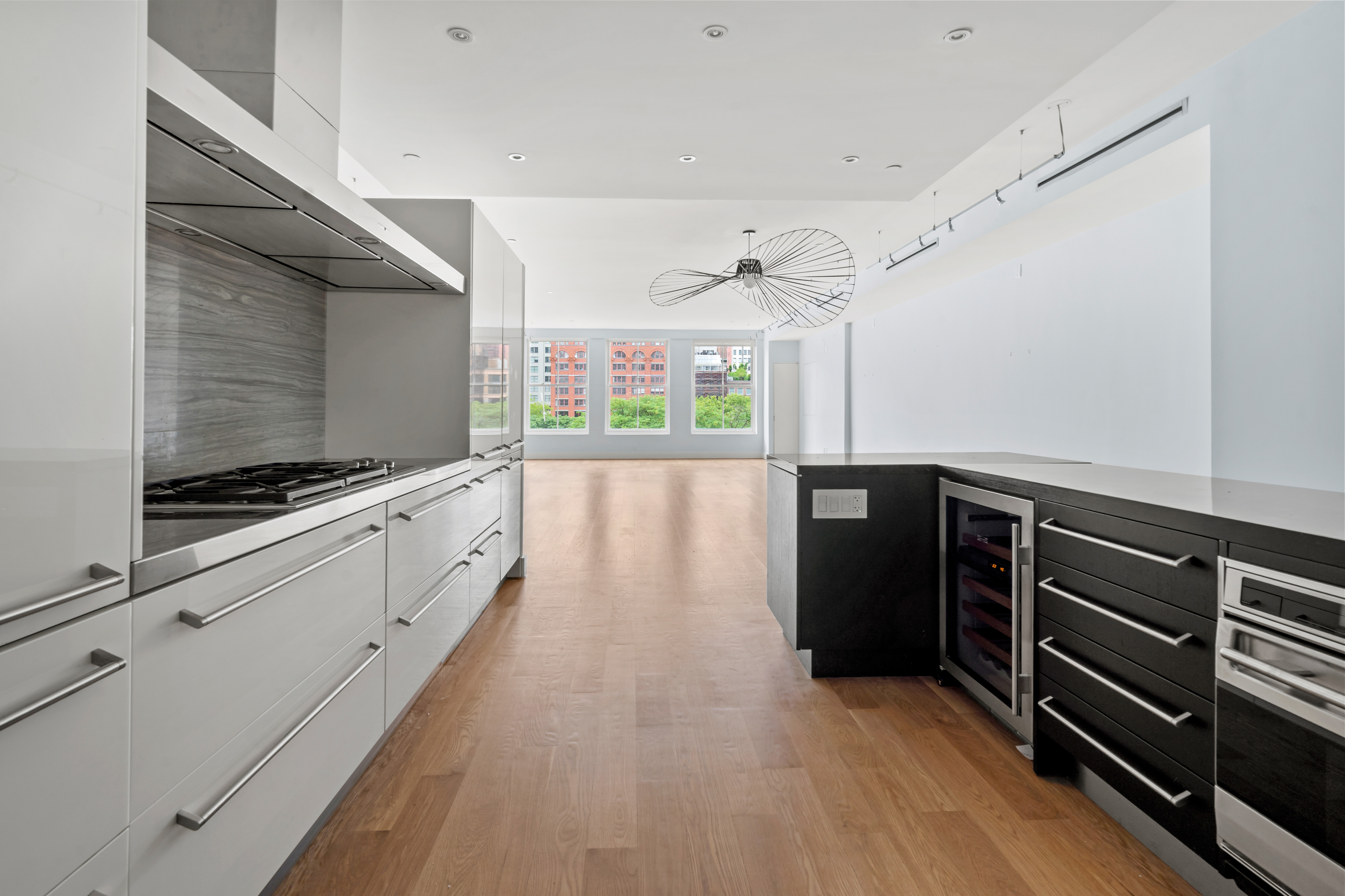 32 Laight Street, Unit 5 Manhattan, NY 10013 - Photo 14 of 31 a kitchen with stainless steel appliances kitchen island granite countertop a stove and a microwave
