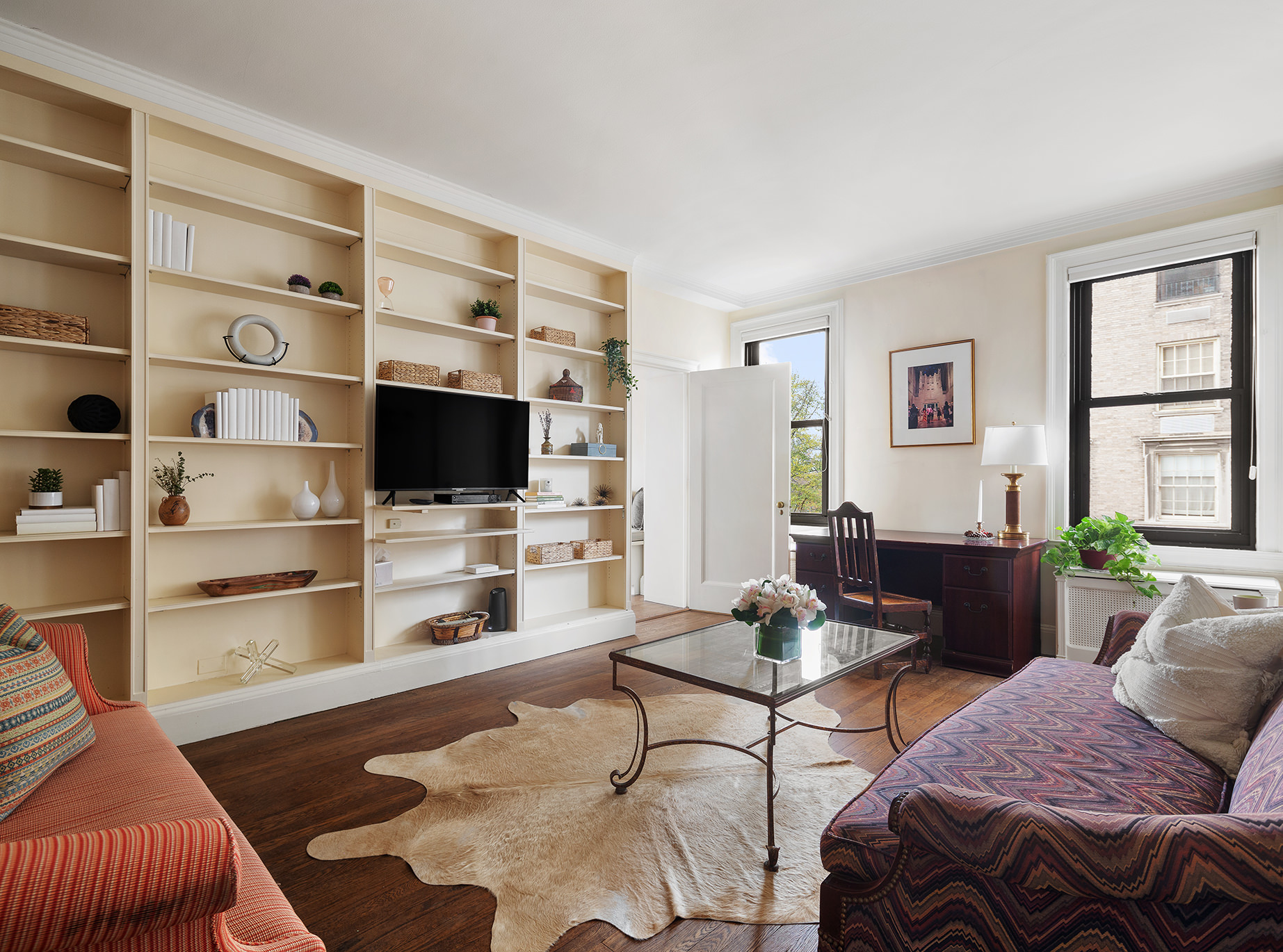 1115 5th Avenue, Unit 5B Manhattan, NY 10128 - Photo 5 of 19 a living room with furniture and a flat screen tv