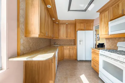 a kitchen with a refrigerator and a stove