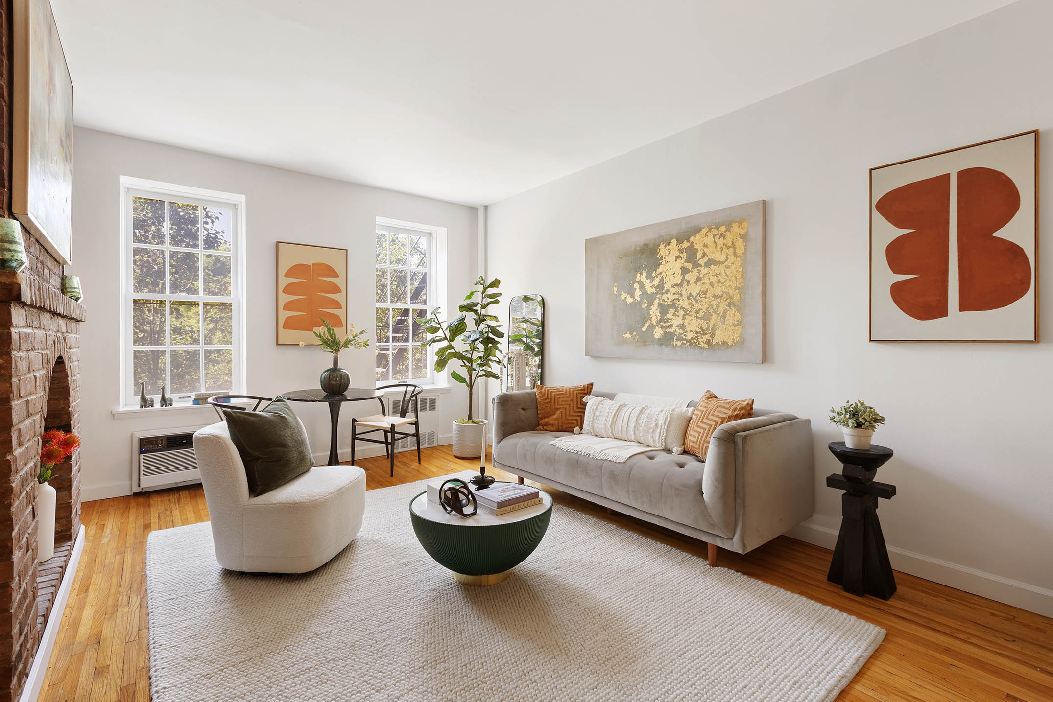 333 West 21st Street, Unit 2FE Manhattan, NY 10011 - Photo 2 of 10 a living room with furniture and a potted plant